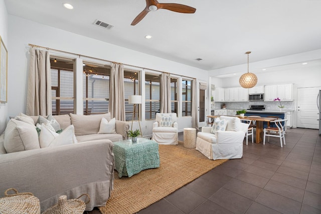 1518 Frontier Valley Dr, Austin, TX 78741 - living area with dark tile patterned flooring, a ceiling fan, and recessed lighting