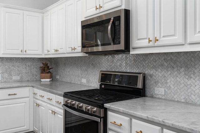 1518 Frontier Valley Dr, Austin, TX 78741 - kitchen with stainless steel appliances, white cabinets, and decorative backsplash