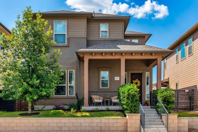 1518 Frontier Valley Dr, Austin, TX 78741 - view of front of property featuring a porch, stairway, stucco siding, and a shingled roof