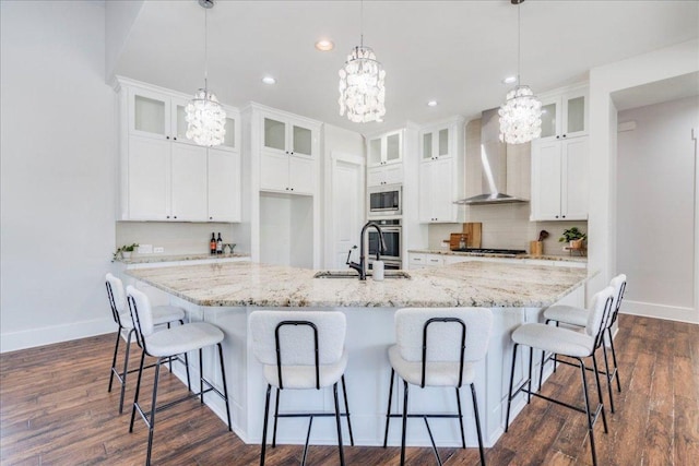 605 Unity Dr, Leander, TX 78641 - kitchen with wall chimney exhaust hood, a sink, a chandelier, baseboards, and recessed lighting