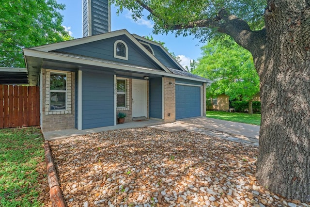 8508 Croydon Loop, Austin, TX 78748 - view of front of home featuring brick siding, a chimney, an attached garage, concrete driveway, and covered porch