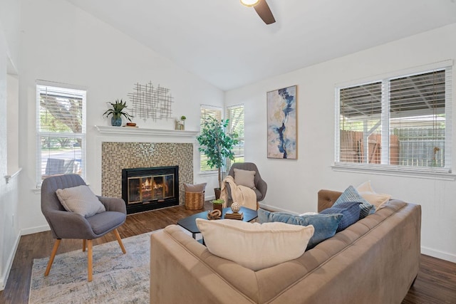 8508 Croydon Loop, Austin, TX 78748 - living area featuring vaulted ceiling, a ceiling fan, a tiled fireplace, baseboards, and dark wood-style floors