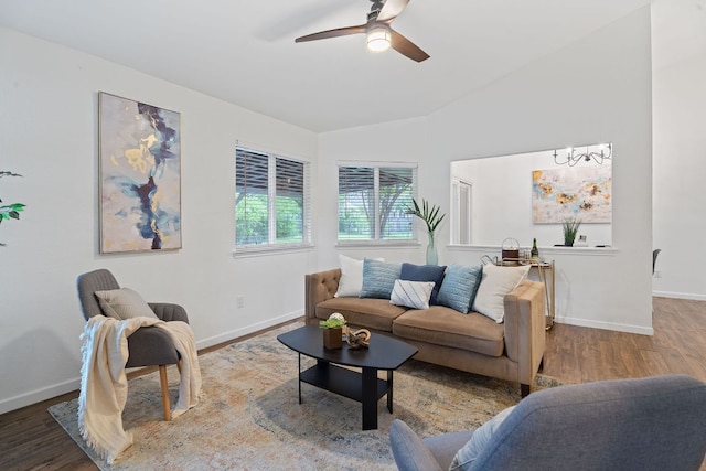 8508 Croydon Loop, Austin, TX 78748 - living room with ceiling fan, wood finished floors, baseboards, vaulted ceiling, and a chandelier