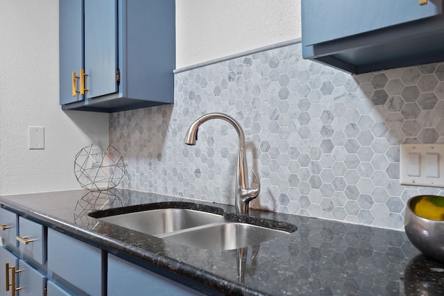 8508 Croydon Loop, Austin, TX 78748 - kitchen view of a sink, blue cabinets, decorative backsplash, and dark stone countertops