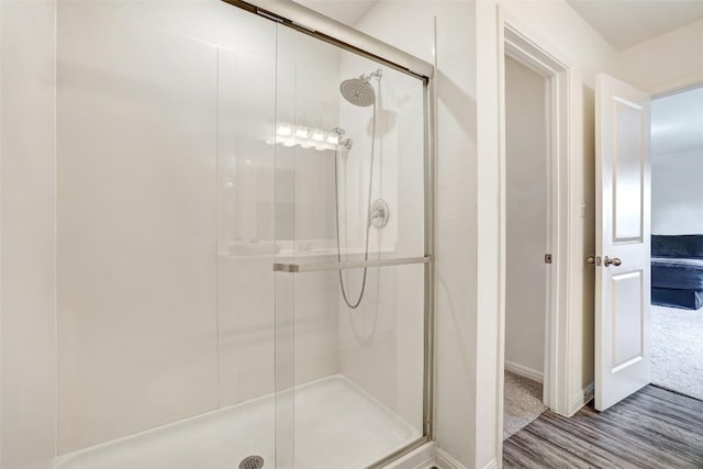 163 Wonderful Life Way, Jarrell, TX 76537 - bathroom with a stall shower, wood finished floors, and baseboards