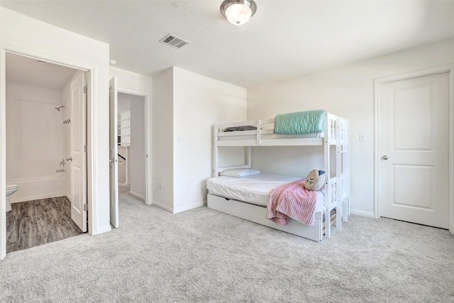 163 Wonderful Life Way, Jarrell, TX 76537 - bedroom with carpet, baseboards, and ensuite bathroom
