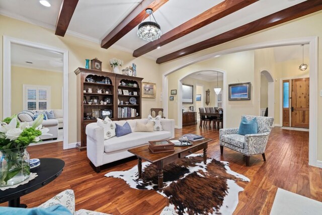 1221 Havre Lafitte Dr, Austin, TX 78746 - living area featuring arched walkways, hardwood / wood-style flooring, beam ceiling, and a chandelier