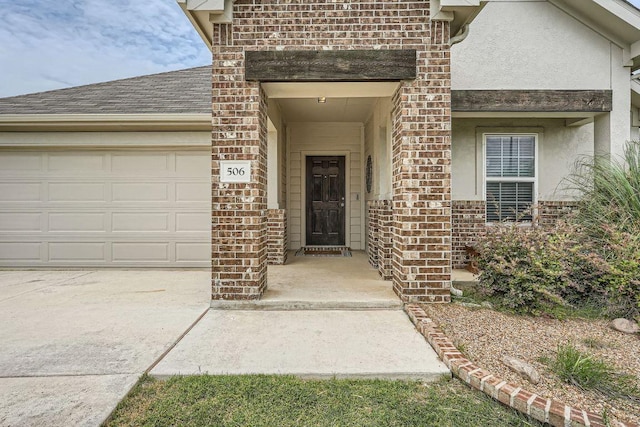 506 Hendelson Ln, Hutto, TX 78634 - entrance to property with brick siding, a garage, stucco siding, driveway, and roof with shingles