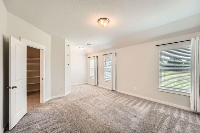 506 Hendelson Ln, Hutto, TX 78634 - unfurnished room featuring carpet flooring and plenty of natural light