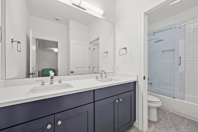 2625 Arion Cir, Austin, TX 78730 - full bath with double vanity, toilet, combined bath / shower with glass door, and marble look tiles