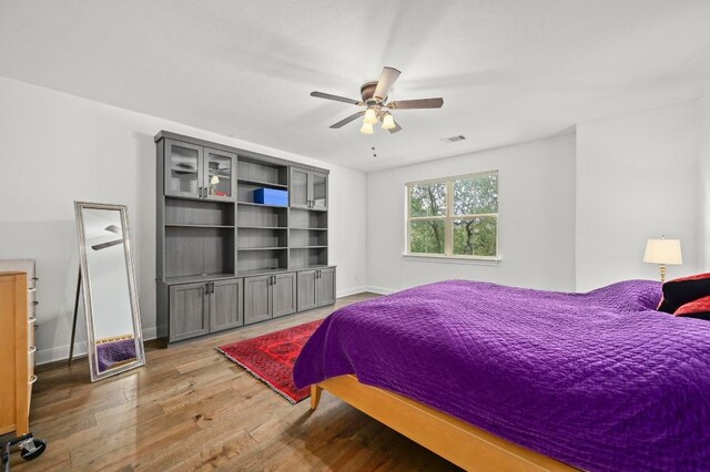 2625 Arion Cir, Austin, TX 78730 - bedroom with wood finished floors, baseboards, and a ceiling fan