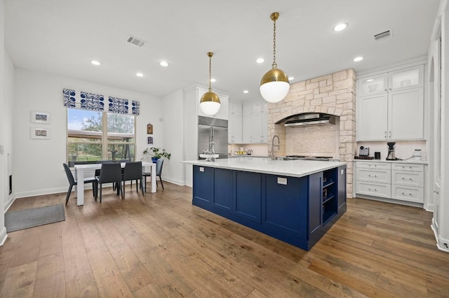 2625 Arion Cir, Austin, TX 78730 - kitchen with blue cabinetry, built in refrigerator, light countertops, white cabinets, and dark wood-style flooring
