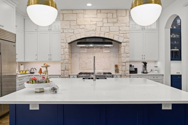 2625 Arion Cir, Austin, TX 78730 - kitchen with stainless steel built in refrigerator, tasteful backsplash, exhaust hood, light stone counters, and recessed lighting