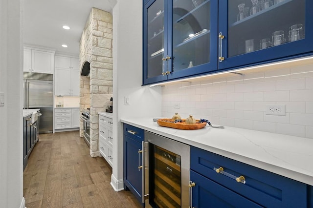 2625 Arion Cir, Austin, TX 78730 - bar featuring wine cooler, built in fridge, dark wood-style floors, tasteful backsplash, and recessed lighting