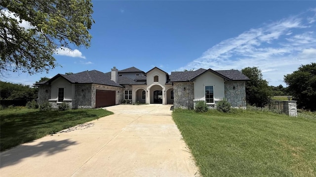 128 Gloria Blvd, Smithville, TX 78957 - french provincial home with stone siding, stucco siding, an attached garage, driveway, and a chimney