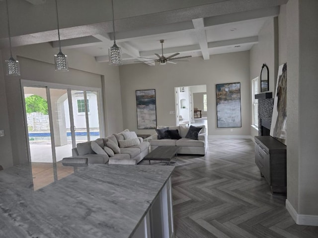 128 Gloria Blvd, Smithville, TX 78957 - living room featuring coffered ceiling, ceiling fan, beamed ceiling, a high ceiling, and a fireplace