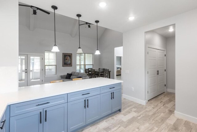 116 Mallard Rd, Bastrop, TX 78602 - kitchen with a peninsula, light wood-style floors, pendant lighting, light countertops, and baseboards