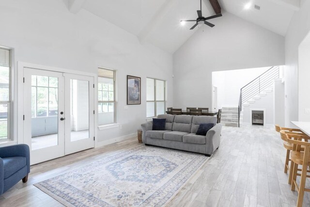 116 Mallard Rd, Bastrop, TX 78602 - living area featuring high vaulted ceiling, french doors, light wood-style flooring, beam ceiling, and stairs