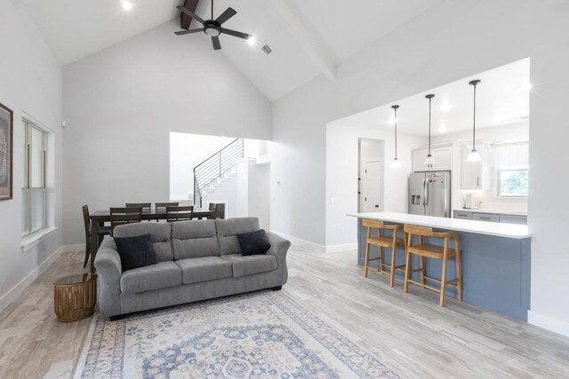 116 Mallard Rd, Bastrop, TX 78602 - living room featuring high vaulted ceiling, a ceiling fan, light wood-style flooring, stairs, and baseboards