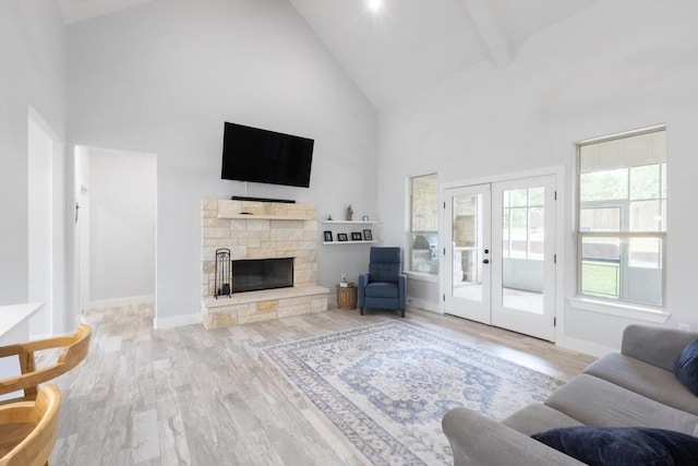116 Mallard Rd, Bastrop, TX 78602 - living room with high vaulted ceiling, wood finished floors, french doors, a fireplace, and baseboards