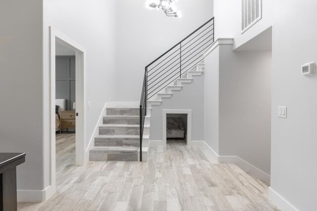 116 Mallard Rd, Bastrop, TX 78602 - foyer entrance with stairway, light wood-type flooring, a high ceiling, and baseboards