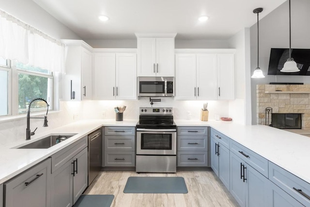 116 Mallard Rd, Bastrop, TX 78602 - kitchen with stainless steel appliances, light countertops, tasteful backsplash, white cabinetry, and light wood-style floors
