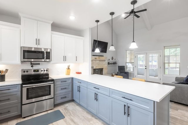 116 Mallard Rd, Bastrop, TX 78602 - kitchen with appliances with stainless steel finishes, open floor plan, a peninsula, light countertops, and beam ceiling