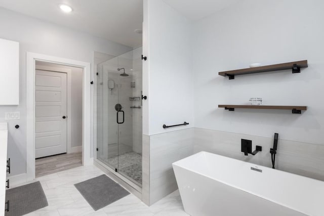 116 Mallard Rd, Bastrop, TX 78602 - full bath featuring a freestanding tub, a stall shower, marble finish floors, and recessed lighting