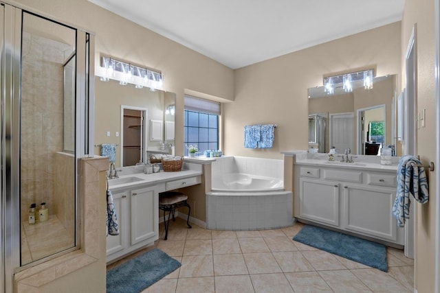 17704 Miller Falls Cv, Round Rock, TX 78681 - bathroom with a shower stall, a bath, two vanities, and tile patterned flooring