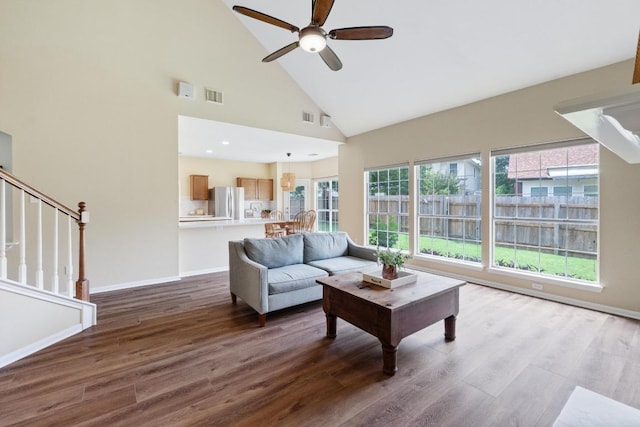 17704 Miller Falls Cv, Round Rock, TX 78681 - living area featuring a ceiling fan, wood finished floors, high vaulted ceiling, and stairway