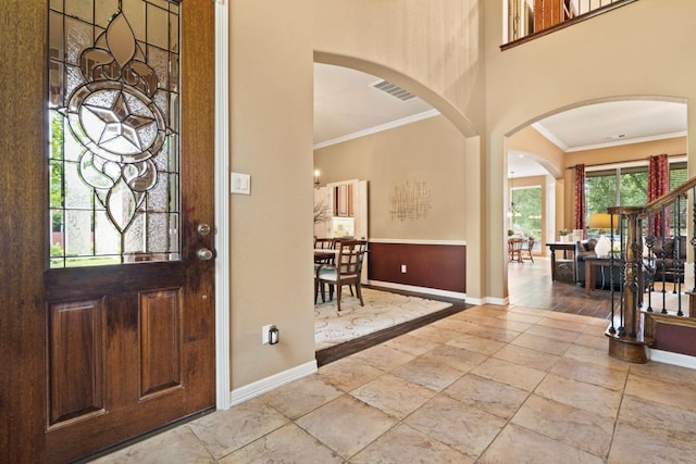 1613 Westend Pl, Round Rock, TX 78681 - entrance foyer featuring ornamental molding, arched walkways, and a towering ceiling