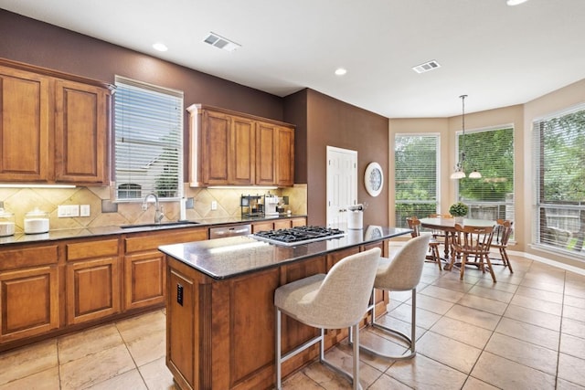 1613 Westend Pl, Round Rock, TX 78681 - kitchen with appliances with stainless steel finishes, brown cabinets, plenty of natural light, and recessed lighting