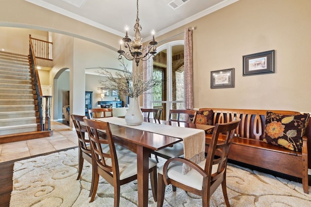 1613 Westend Pl, Round Rock, TX 78681 - dining area with arched walkways, stairway, ornamental molding, and a chandelier