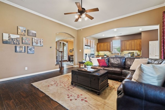 1613 Westend Pl, Round Rock, TX 78681 - living room featuring arched walkways, a ceiling fan, wood finished floors, and ornamental molding