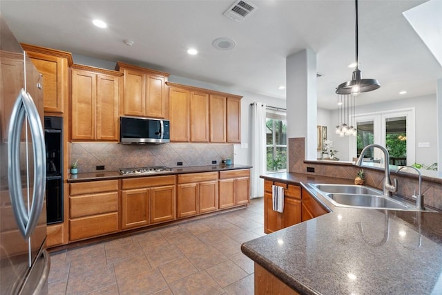 2705 Rosemount Cv, Round Rock, TX 78665 - kitchen featuring stainless steel appliances, a sink, decorative backsplash, decorative light fixtures, and recessed lighting