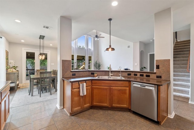 2705 Rosemount Cv, Round Rock, TX 78665 - kitchen with dishwasher, a sink, brown cabinets, ceiling fan, and decorative backsplash