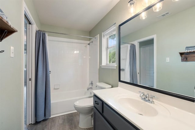 2705 Rosemount Cv, Round Rock, TX 78665 - full bathroom with vanity, wood finished floors, toilet, and shower / bathtub combination with curtain