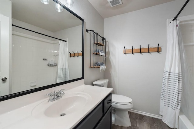 2705 Rosemount Cv, Round Rock, TX 78665 - bathroom featuring vanity, toilet, wood finished floors, and shower / bathtub combination with curtain
