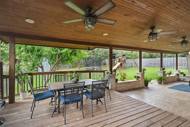 2705 Rosemount Cv, Round Rock, TX 78665 - wooden terrace with a playground, a trampoline, outdoor dining space, ceiling fan, and a patio