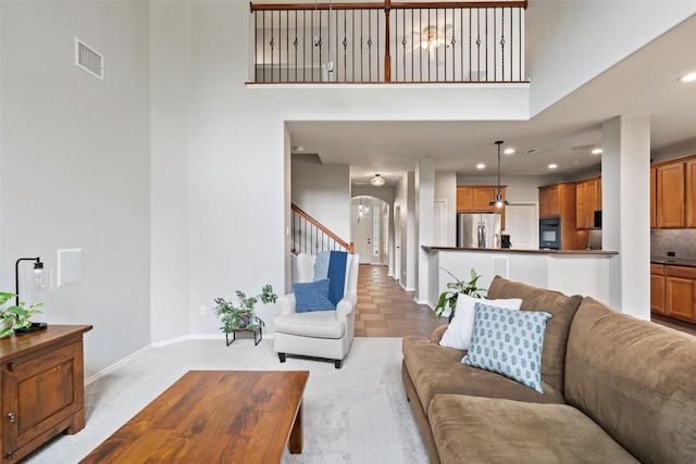 2705 Rosemount Cv, Round Rock, TX 78665 - living area with baseboards, stairs, a towering ceiling, recessed lighting, and arched walkways