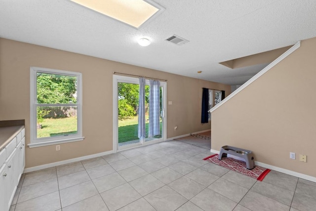 2507 Byfield Dr, Cedar Park, TX 78613 - foyer featuring light tile patterned floors, a textured ceiling, baseboards, and stairs