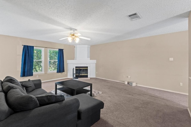 2507 Byfield Dr, Cedar Park, TX 78613 - carpeted living room featuring ceiling fan, baseboards, a textured ceiling, and a high end fireplace