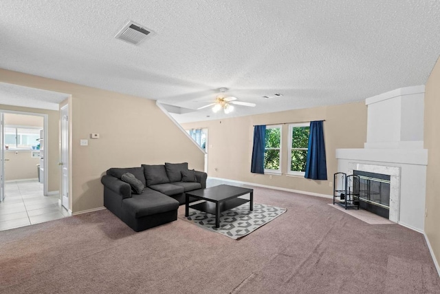 2507 Byfield Dr, Cedar Park, TX 78613 - carpeted living room with a ceiling fan, a textured ceiling, and a premium fireplace
