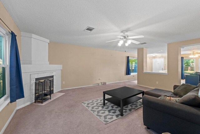 2507 Byfield Dr, Cedar Park, TX 78613 - living area with a ceiling fan, carpet, a textured ceiling, a high end fireplace, and baseboards