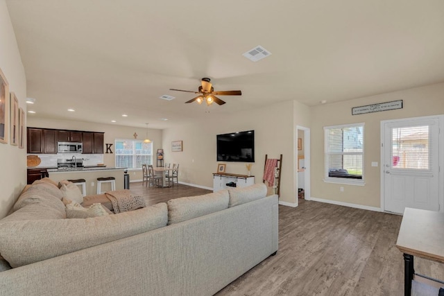 409 Red Matador Ln, Leander, TX 78641 - living area featuring baseboards, light wood-type flooring, healthy amount of natural light, and recessed lighting