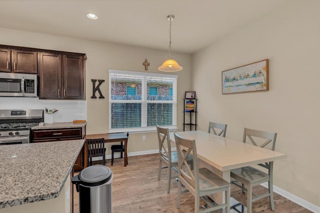 409 Red Matador Ln, Leander, TX 78641 - dining space with light wood-type flooring, baseboards, and recessed lighting