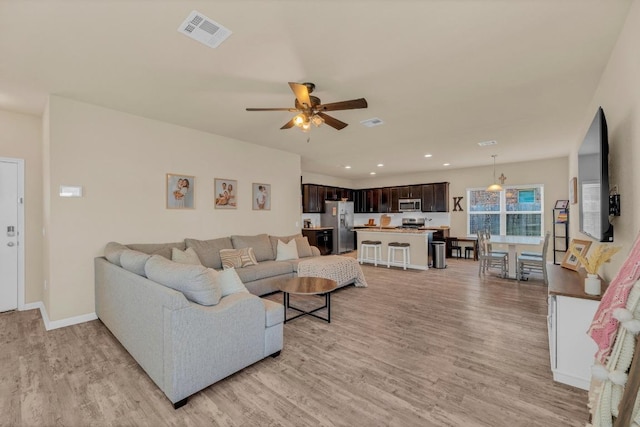 409 Red Matador Ln, Leander, TX 78641 - living area featuring light wood finished floors, ceiling fan, recessed lighting, and baseboards