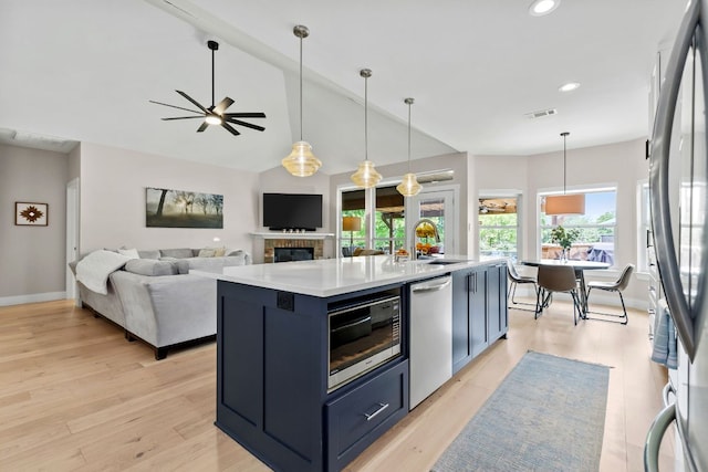 208 E Nakoma, Round Rock, TX 78664 - kitchen featuring stainless steel appliances, a sink, light countertops, light wood-style floors, and recessed lighting