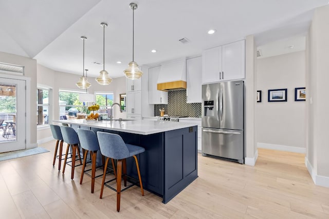 208 E Nakoma, Round Rock, TX 78664 - kitchen featuring stainless steel fridge, custom range hood, a sink, baseboards, and a spacious island