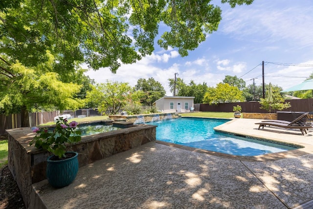 208 E Nakoma, Round Rock, TX 78664 - view of swimming pool with a patio, an outbuilding, a fenced backyard, and a pool with connected hot tub
